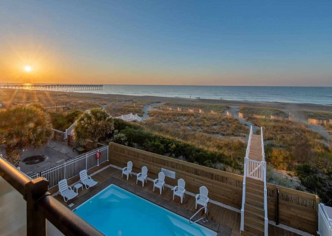 Sunset over beach and pool.