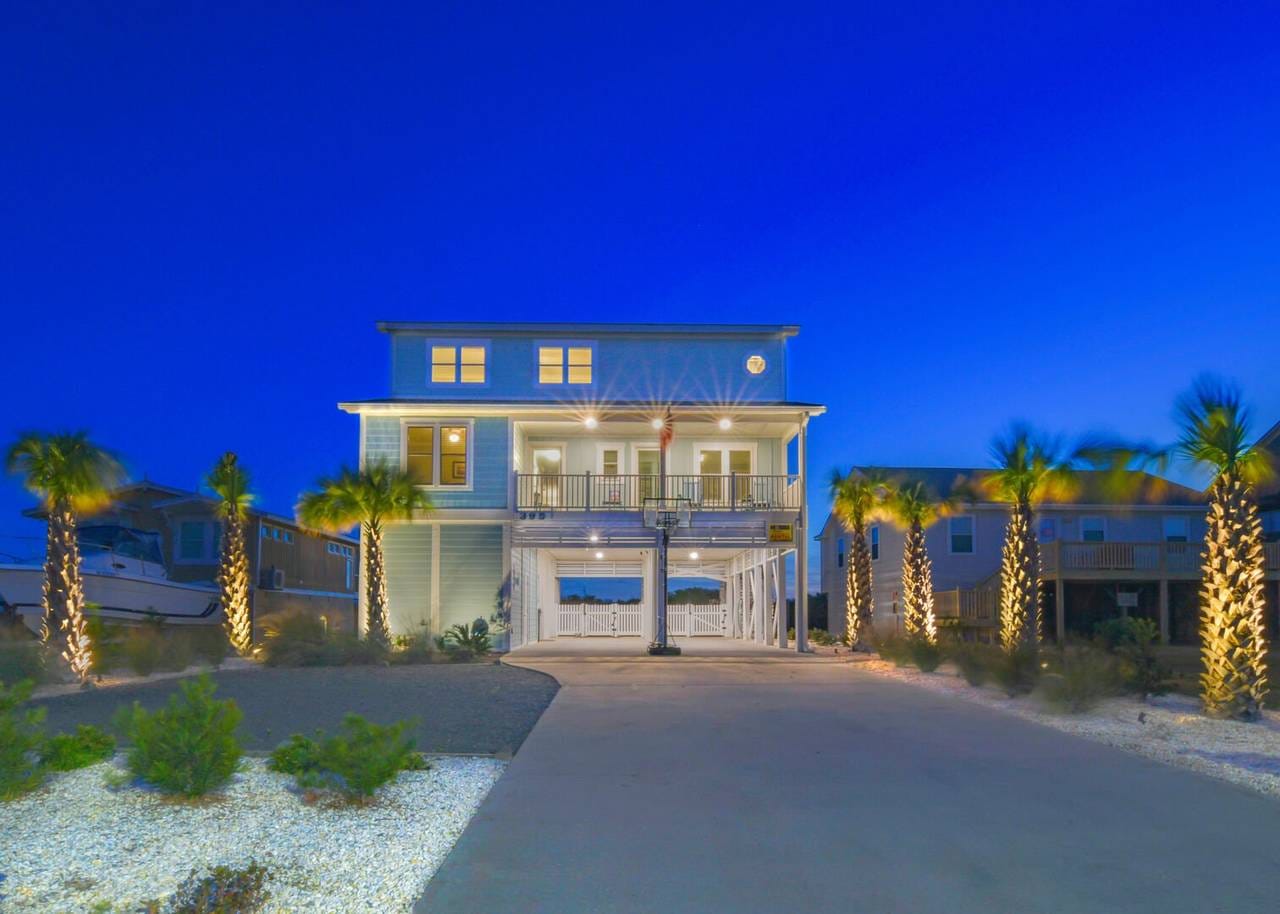 Beach house illuminated at dusk.