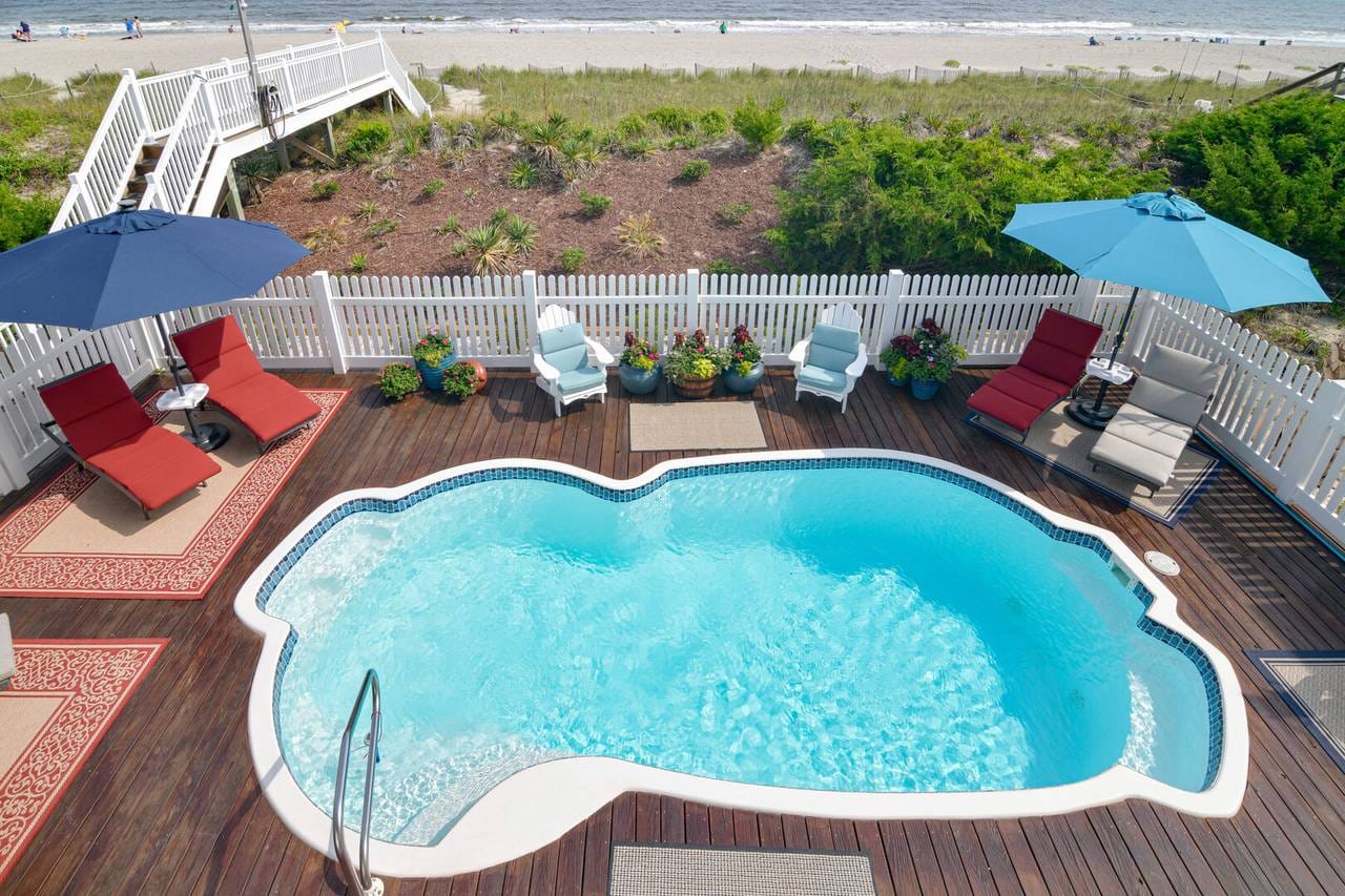 Deck pool overlooking beach path.