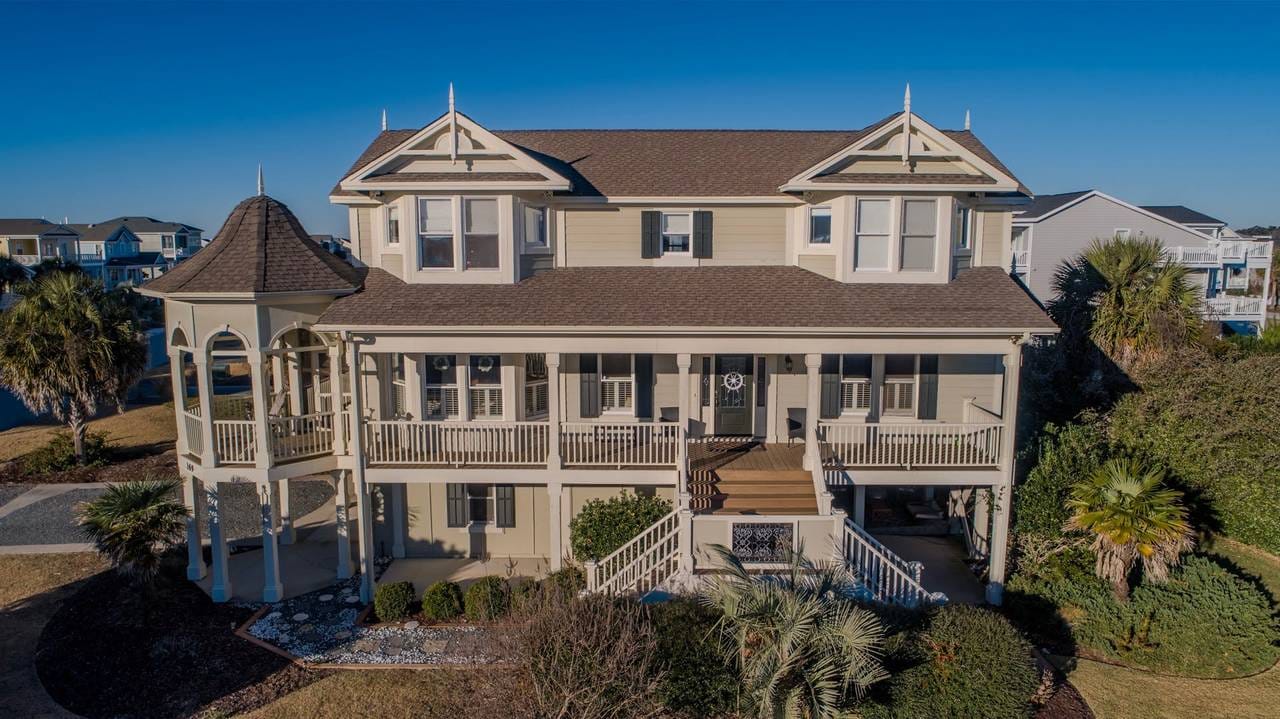 Two-story house with tower feature.