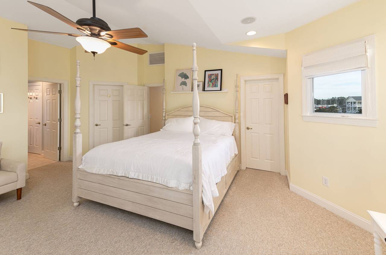 Bedroom with white four-poster bed.