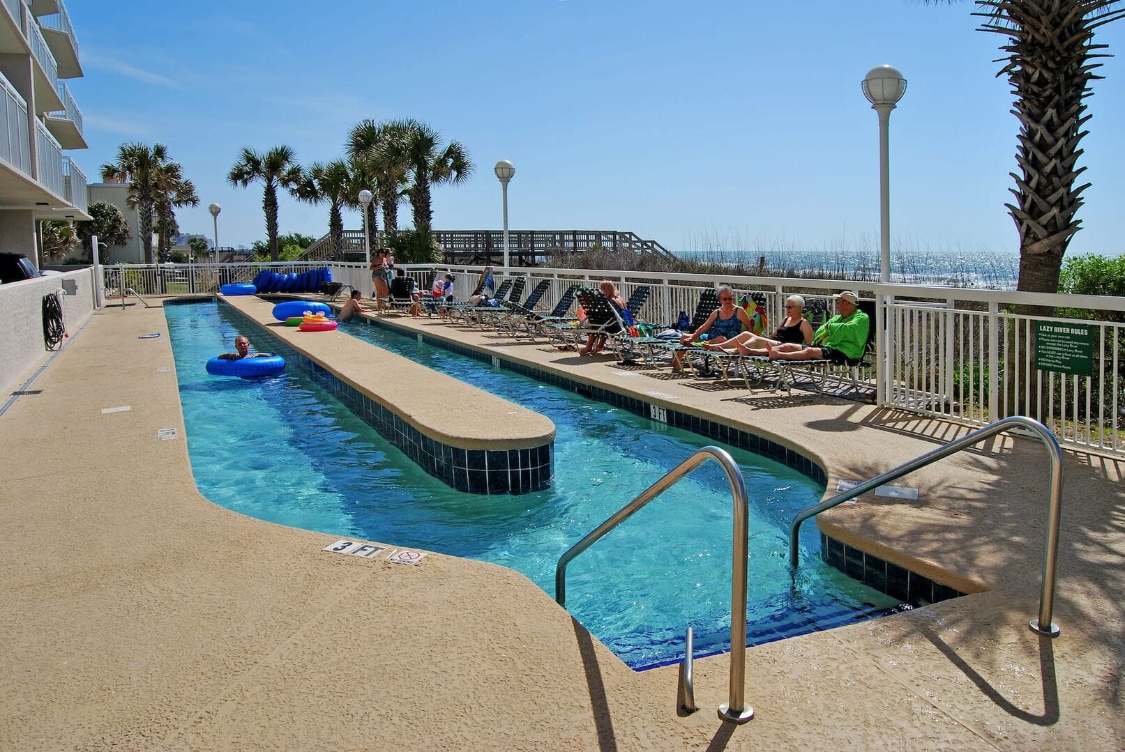 Outdoor pool area with loungers.