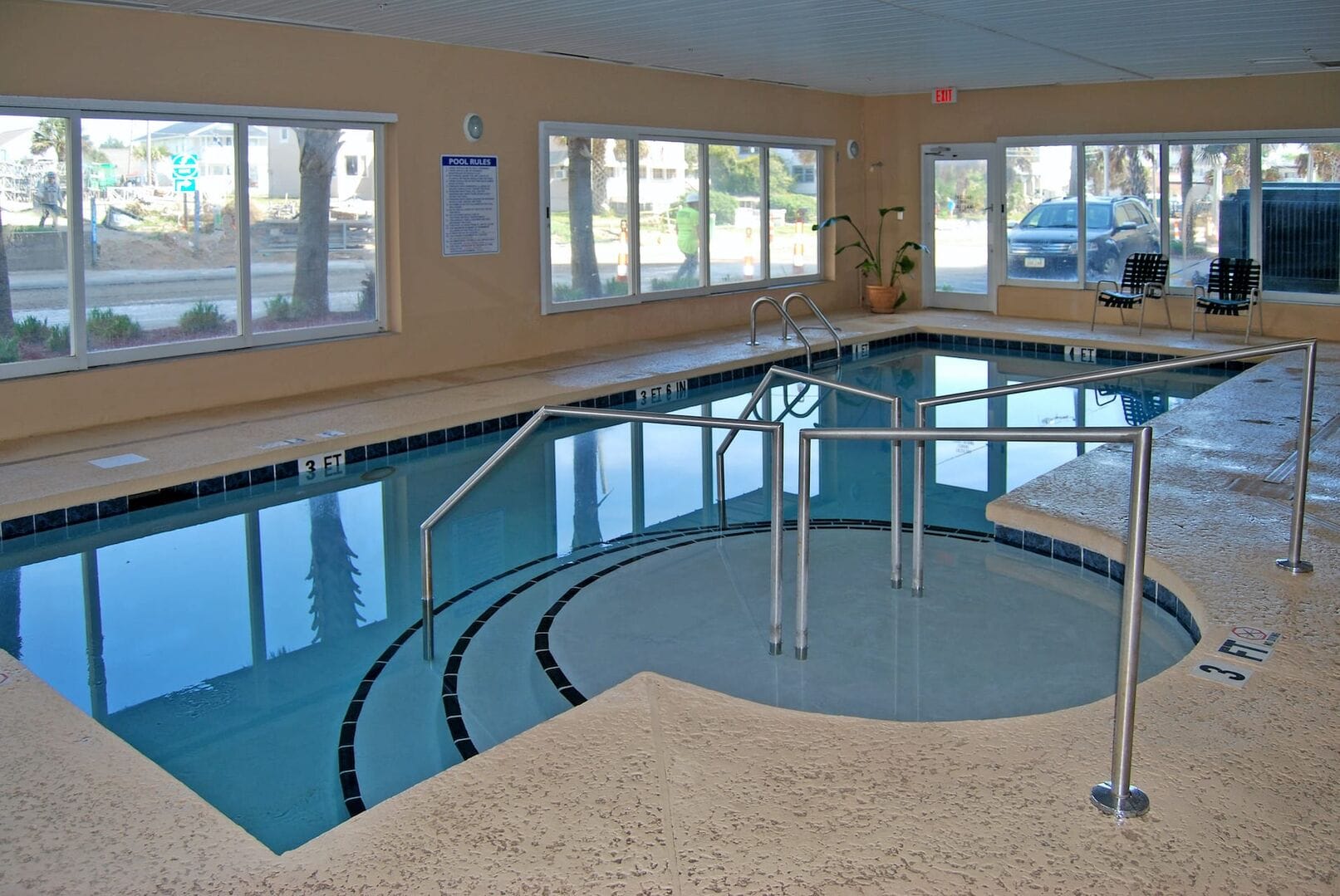 Indoor swimming pool with handrails.