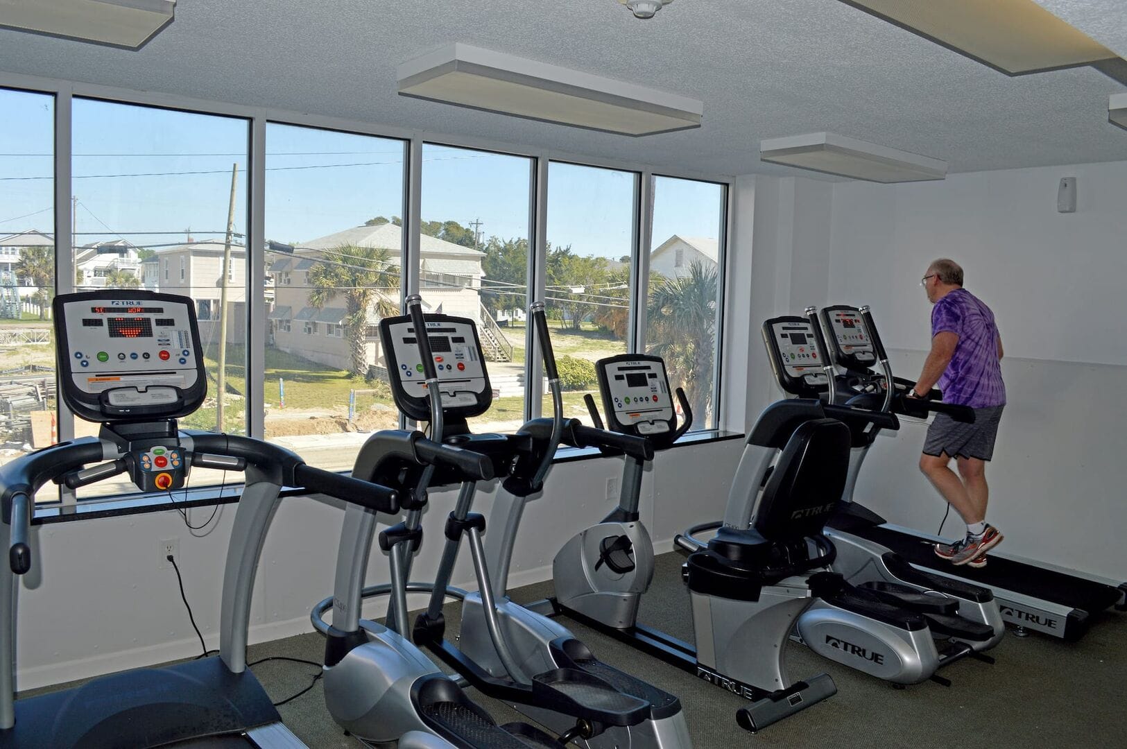 Man on treadmill in gym.