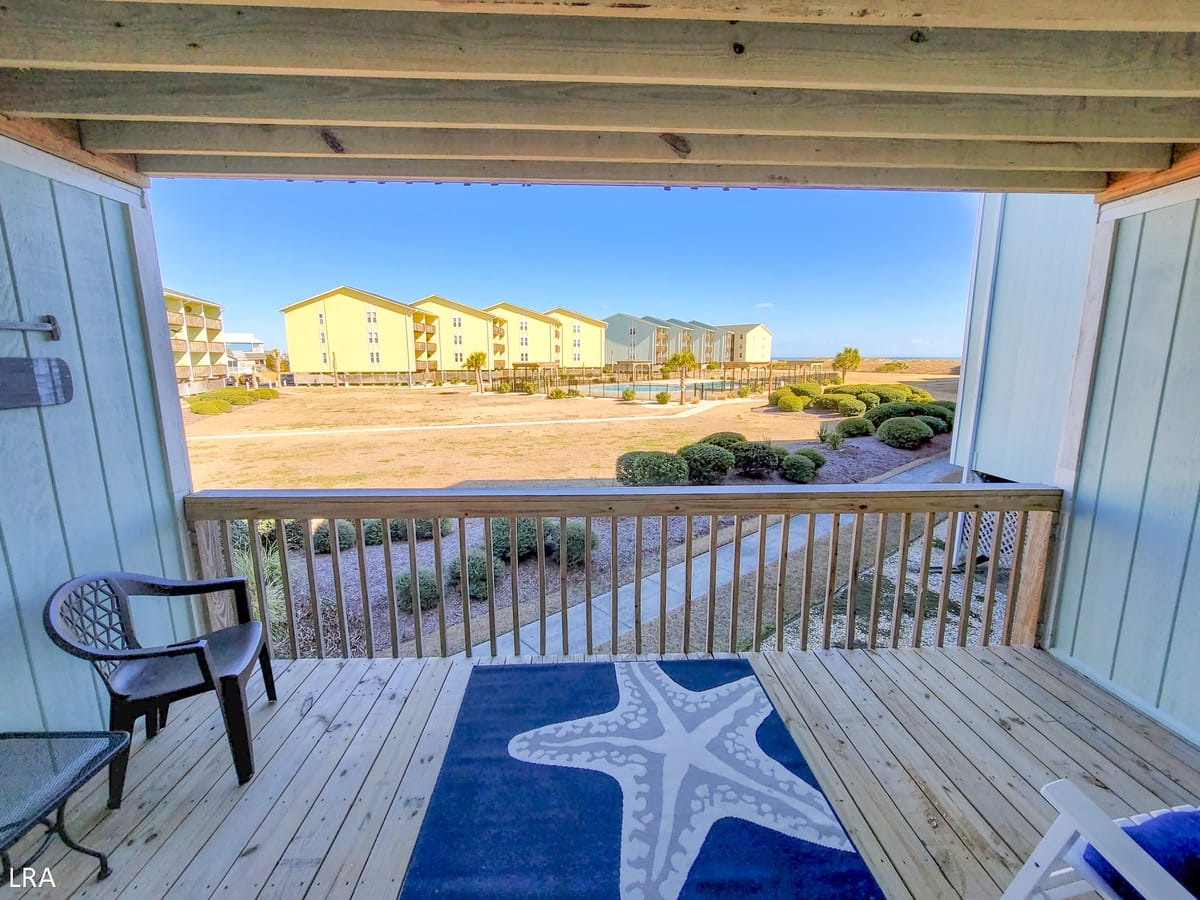 Deck overlooking buildings and landscape.