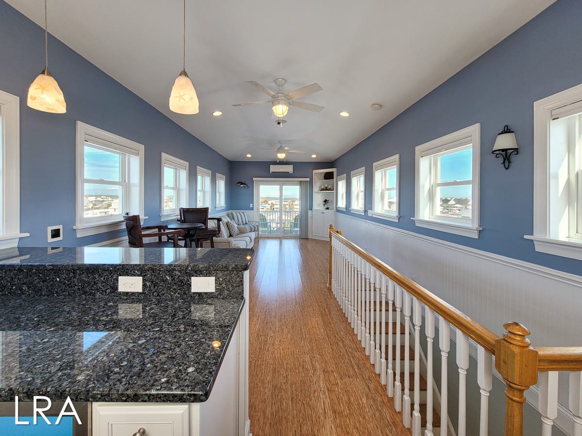 Bright hallway with windows and railing.