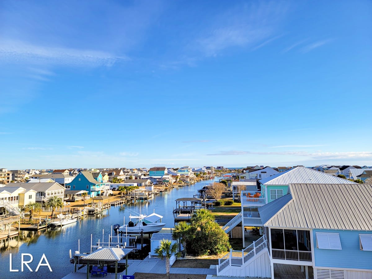 Coastal neighborhood with canals, houses.