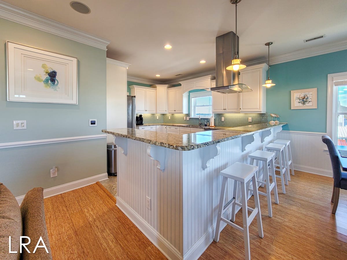 Bright, modern kitchen with bar stools.