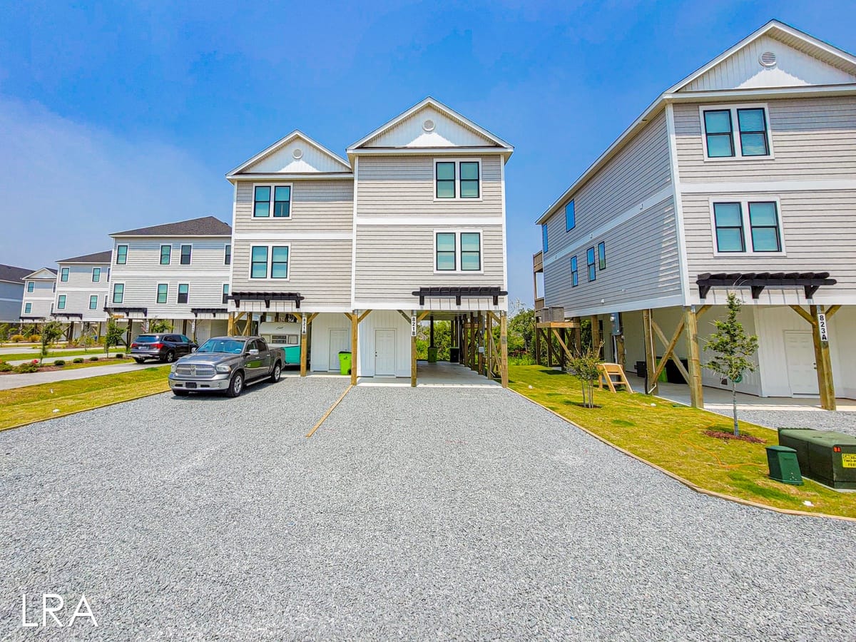 Elevated houses with parked cars.