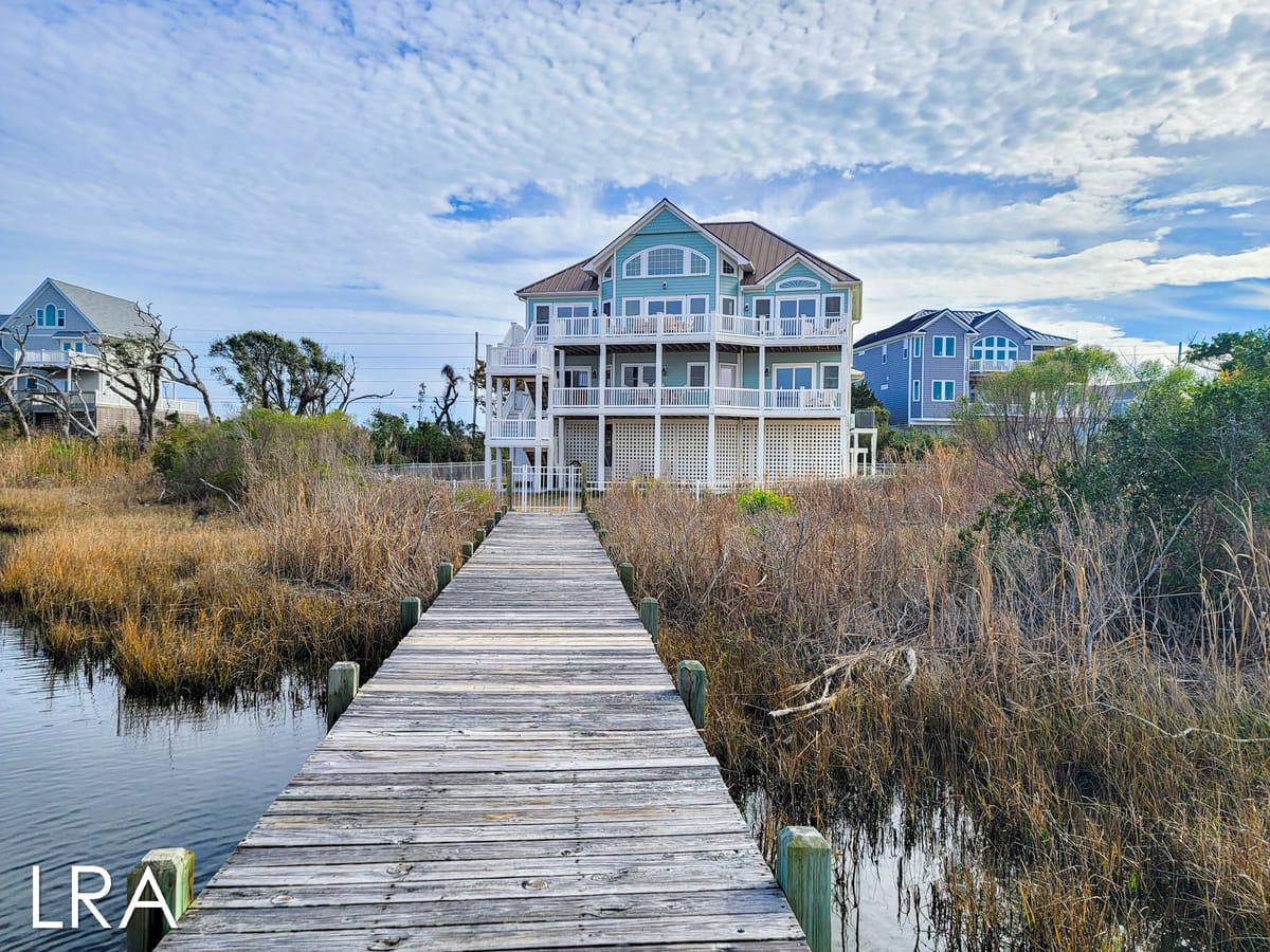 House with boardwalk, marshland view.