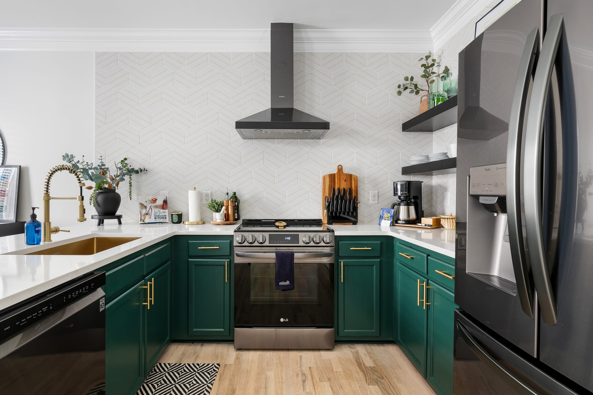 Modern kitchen with green cabinets.