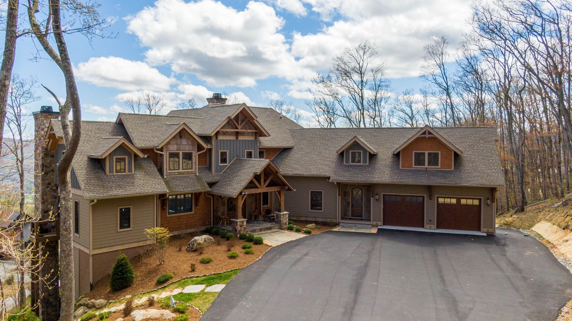 Large rustic house, wooded surroundings.