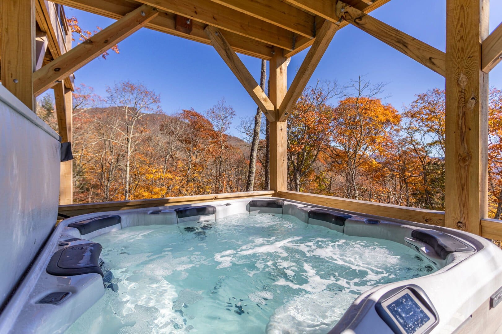 Outdoor hot tub with autumn view.