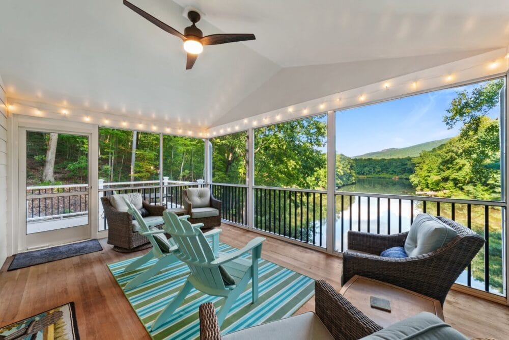 Lakeside screened porch with chairs.