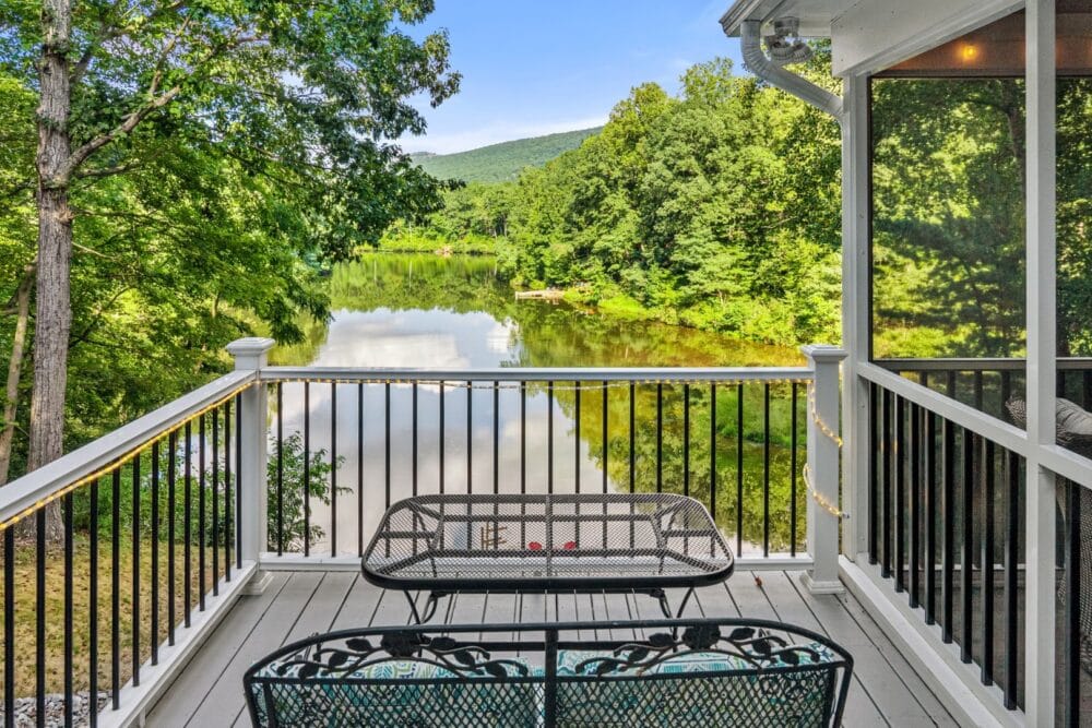 Deck overlooking peaceful lake view.