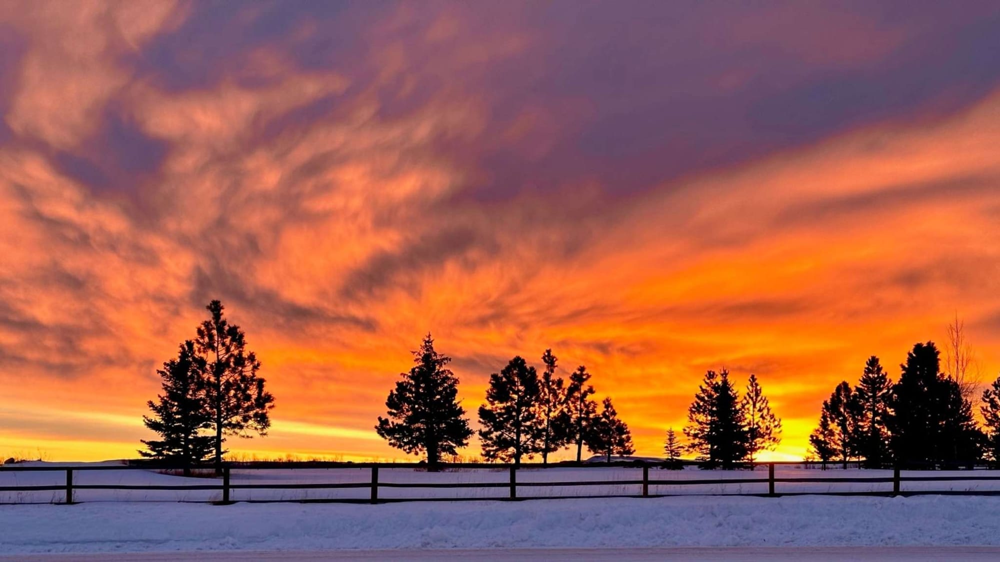 Vibrant sunset over snowy landscape.