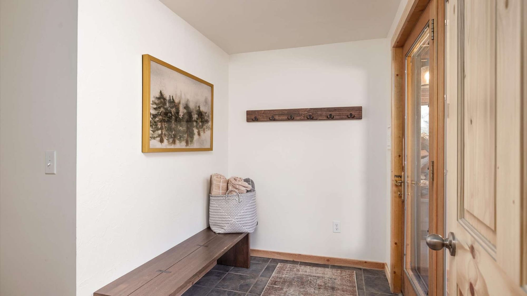 Entryway with bench and painting.