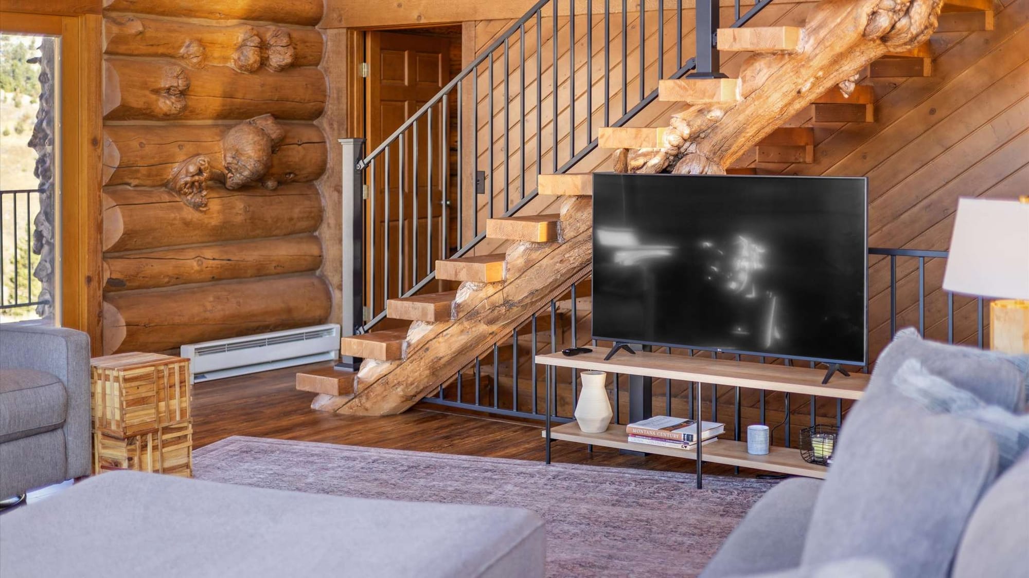 Rustic living room with staircase.