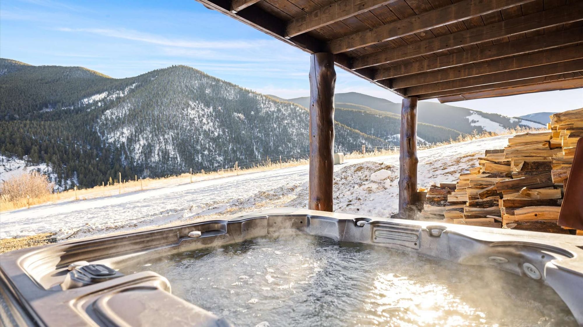 Hot tub with snowy mountain view.