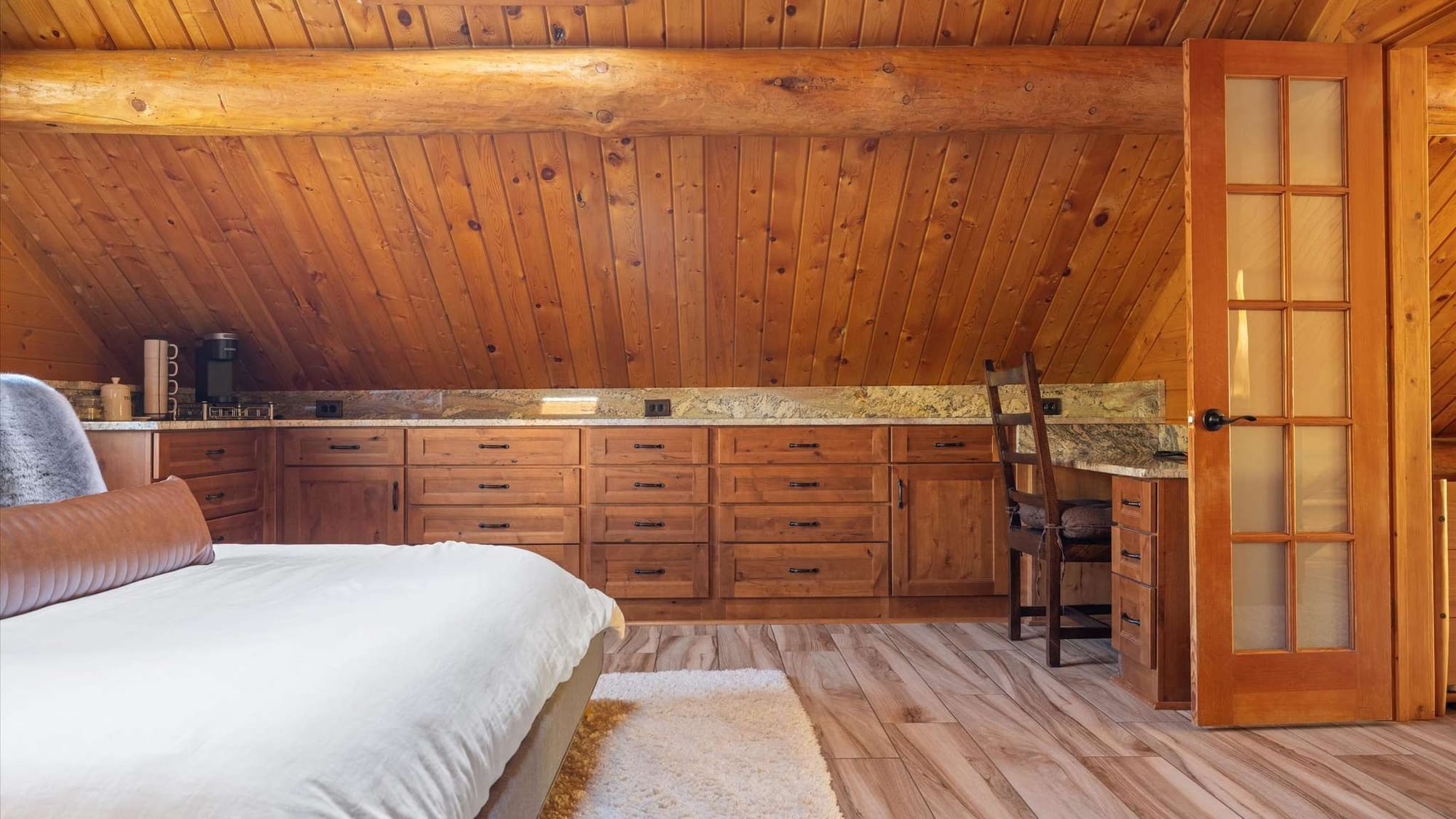 Cozy wooden attic bedroom space.