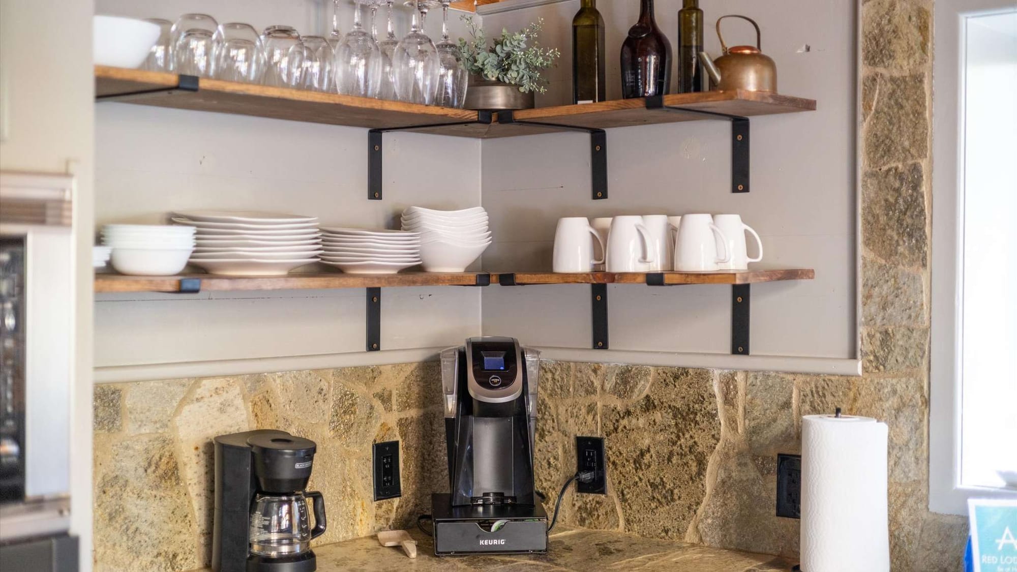 Kitchen shelves with dishes and coffee maker.