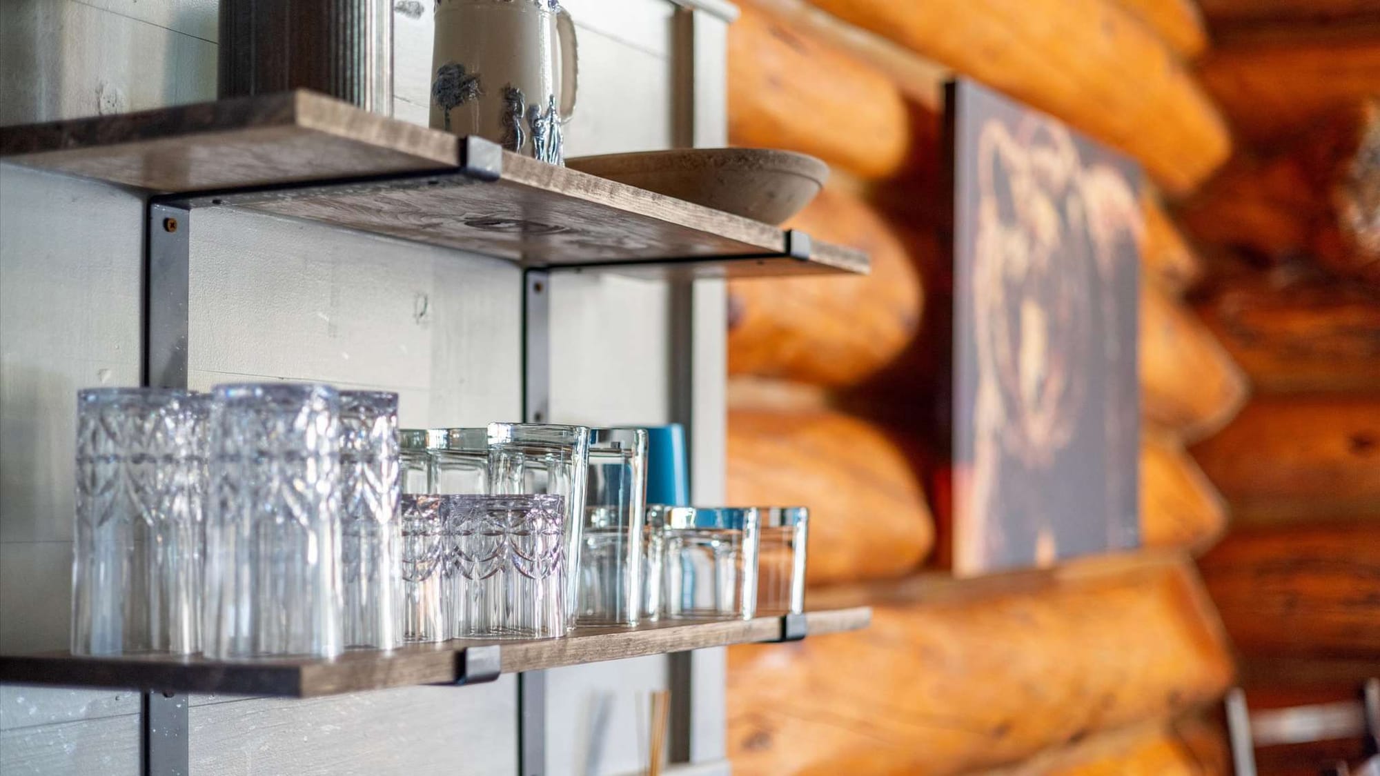 Glasses on rustic wooden shelves.