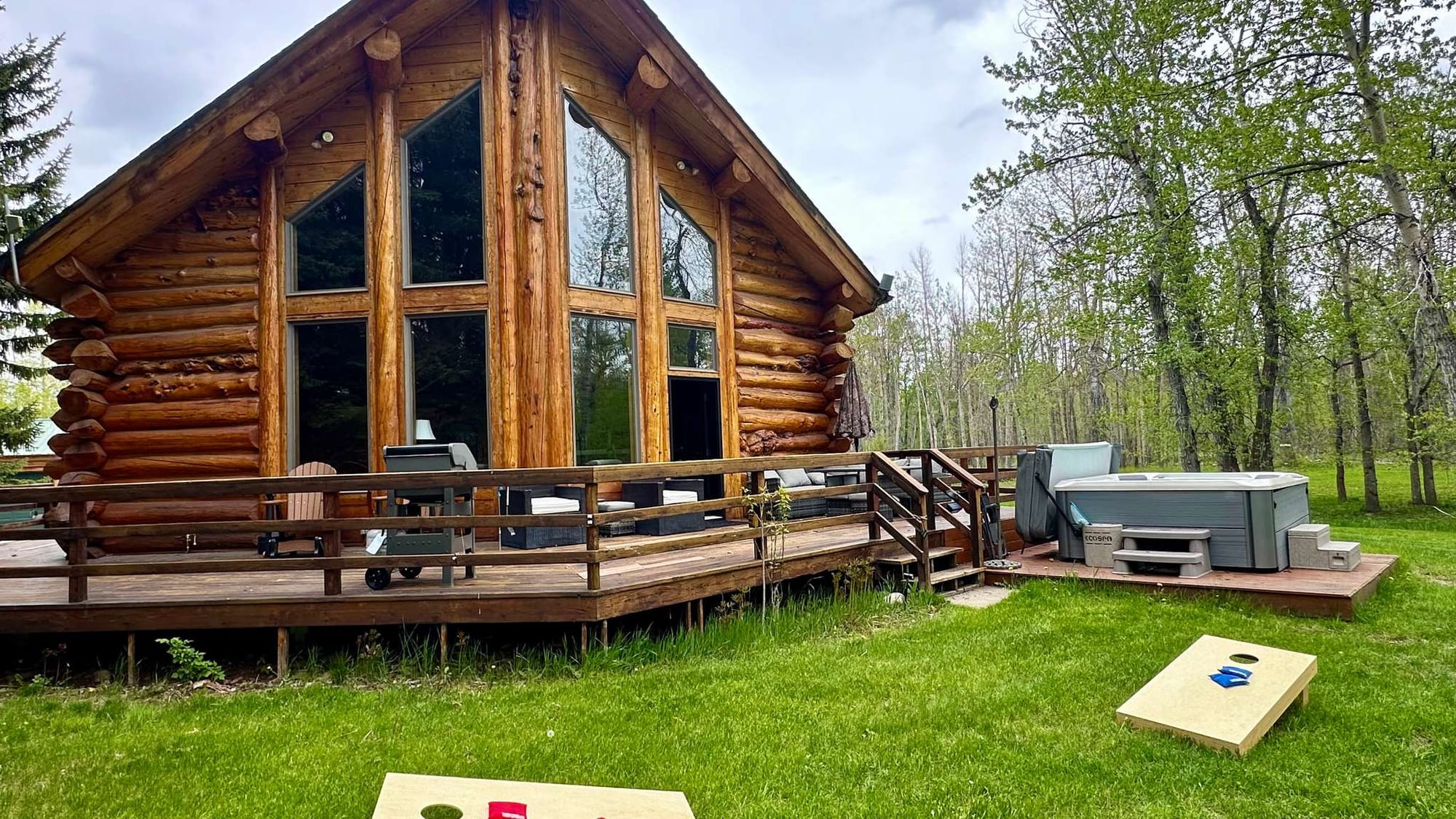 Log cabin with deck and hot tub.