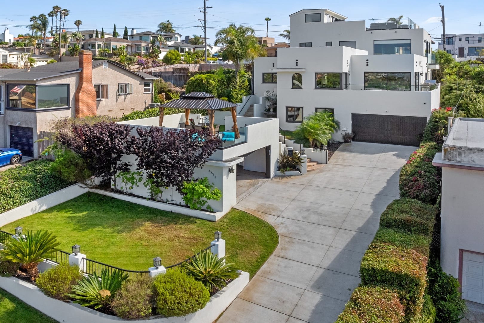 Modern house with large driveway.