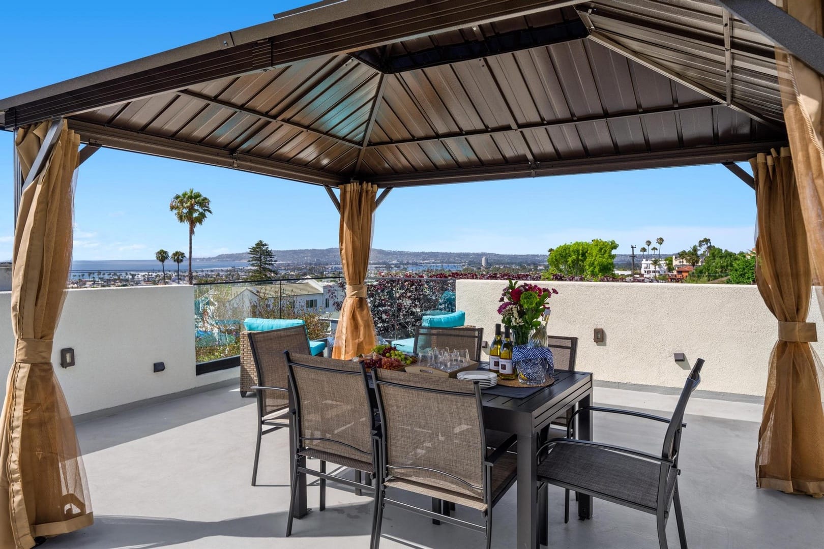 Gazebo with dining set, city view.