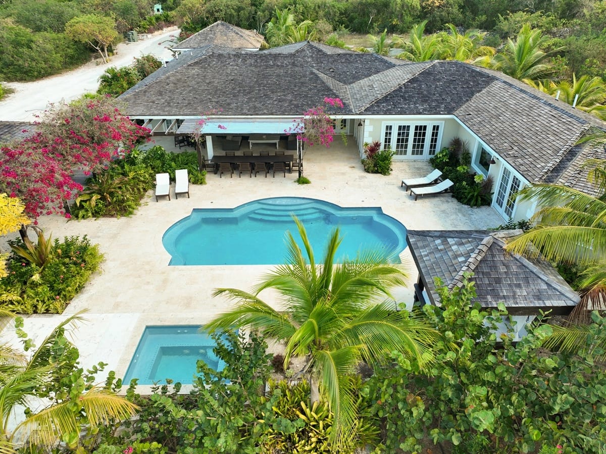 Aerial view of house, pool.