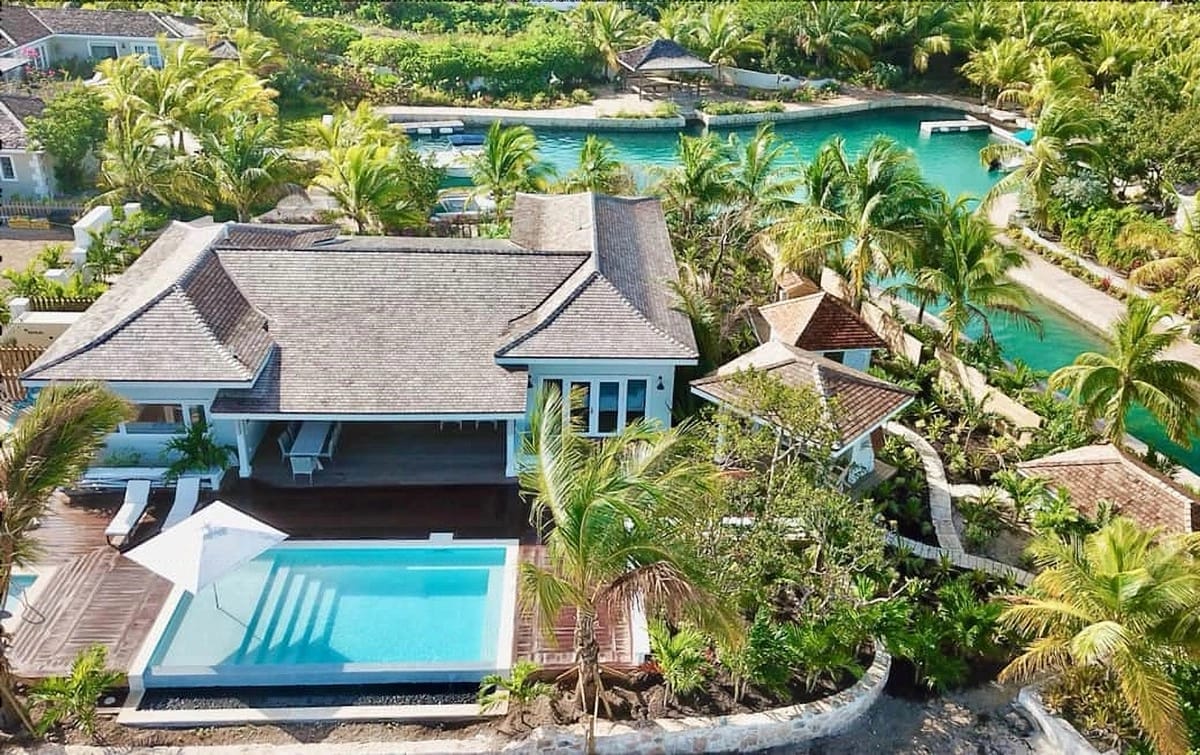 Luxury villa with pool and greenery.