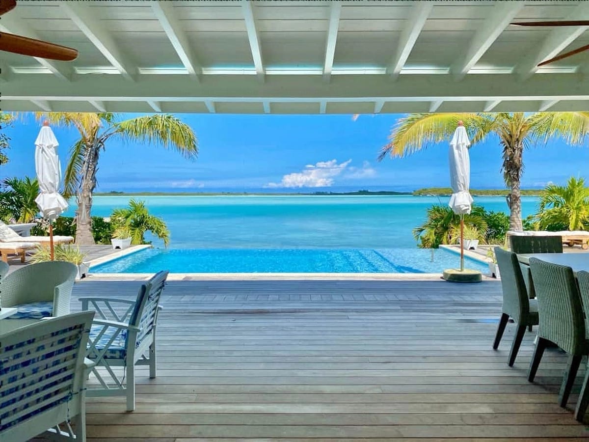 Tropical poolside with ocean view.