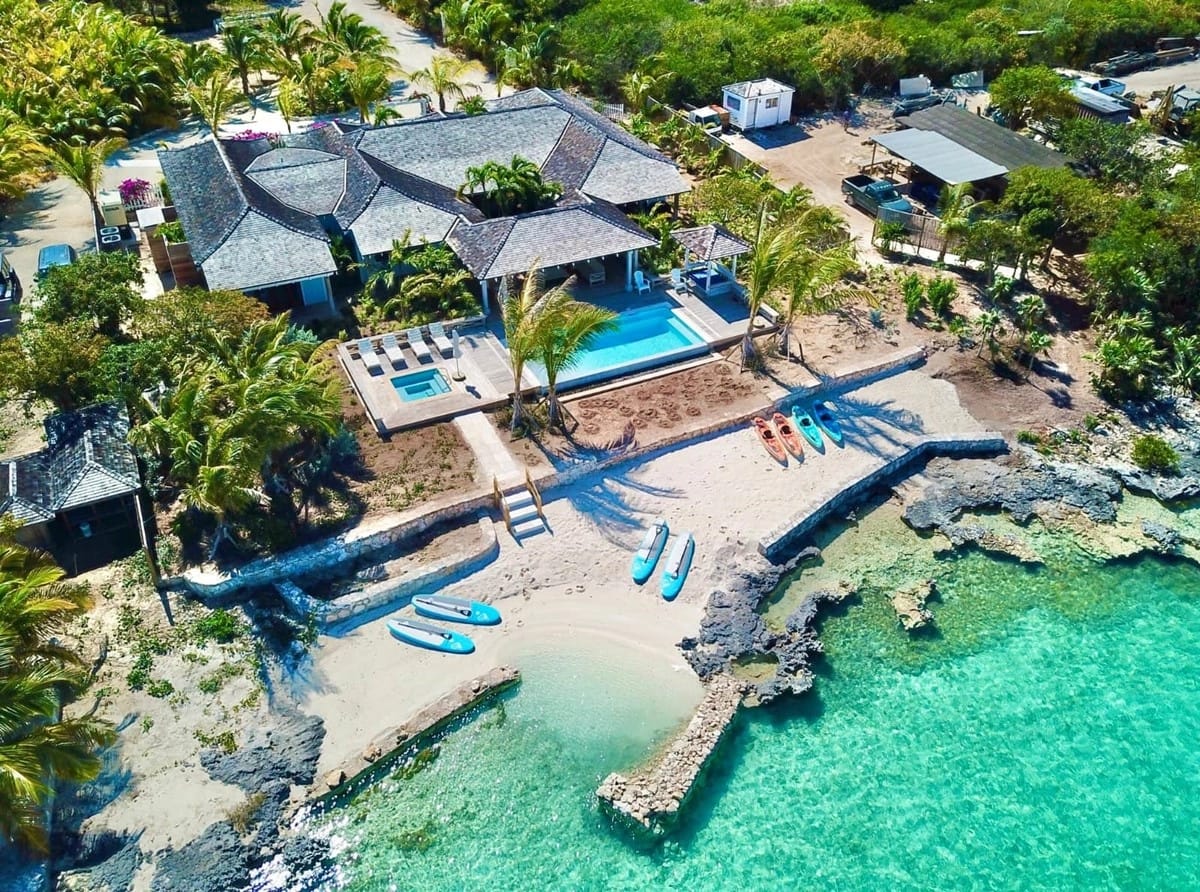 Beachfront house with pool and kayaks.