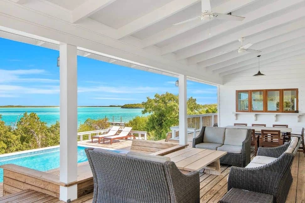 Covered patio overlooking pool and ocean.