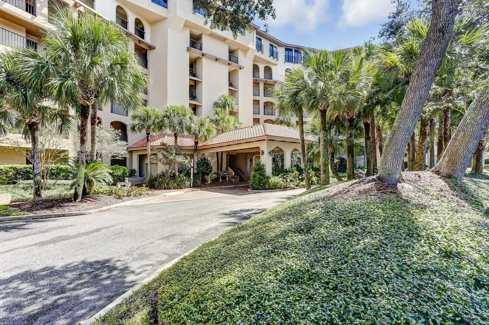 Apartment building with palm trees.