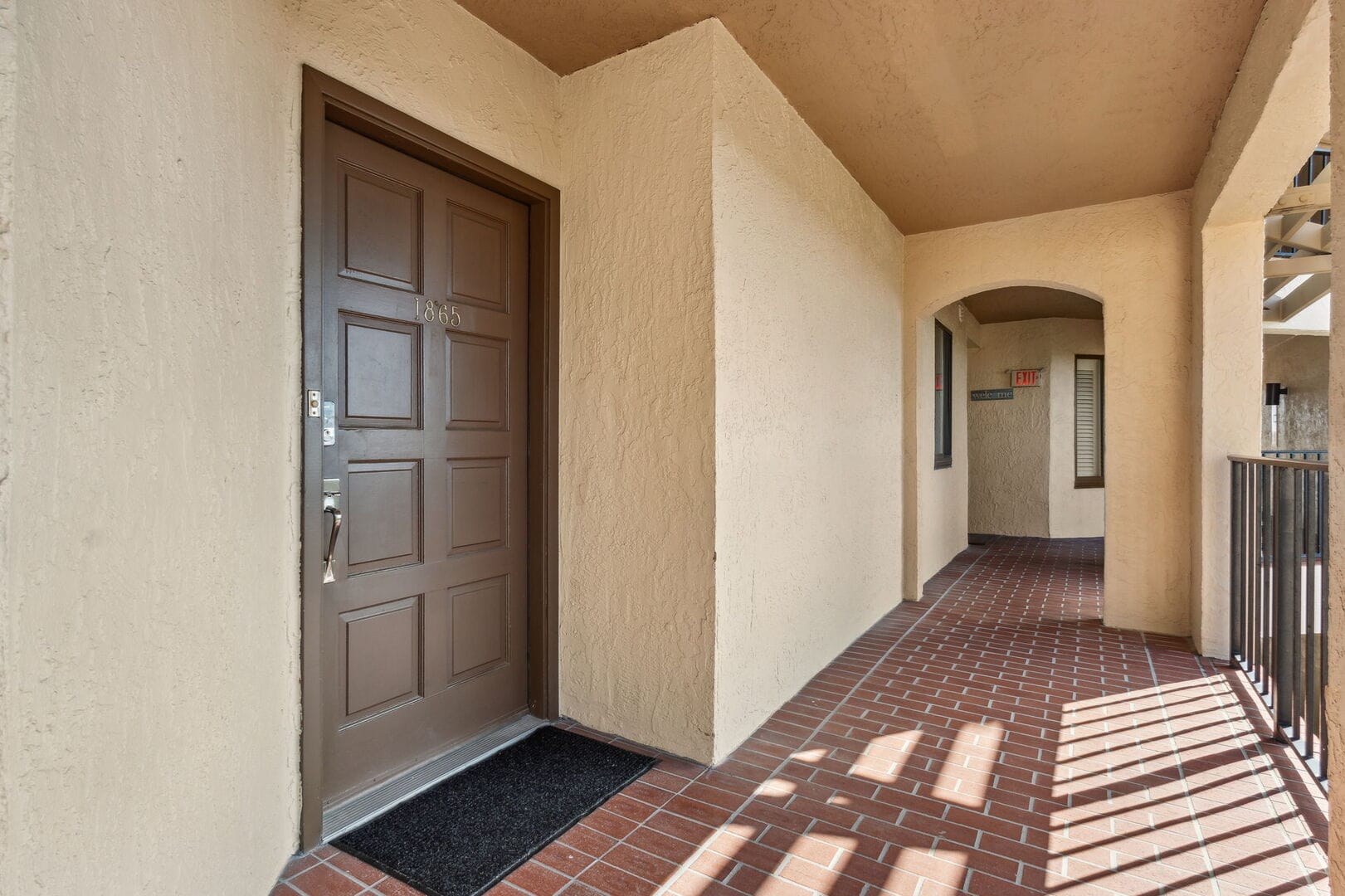 Apartment corridor with brown door.