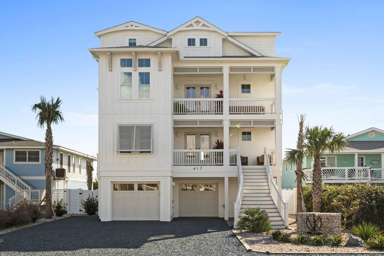 White three-story coastal house exterior.