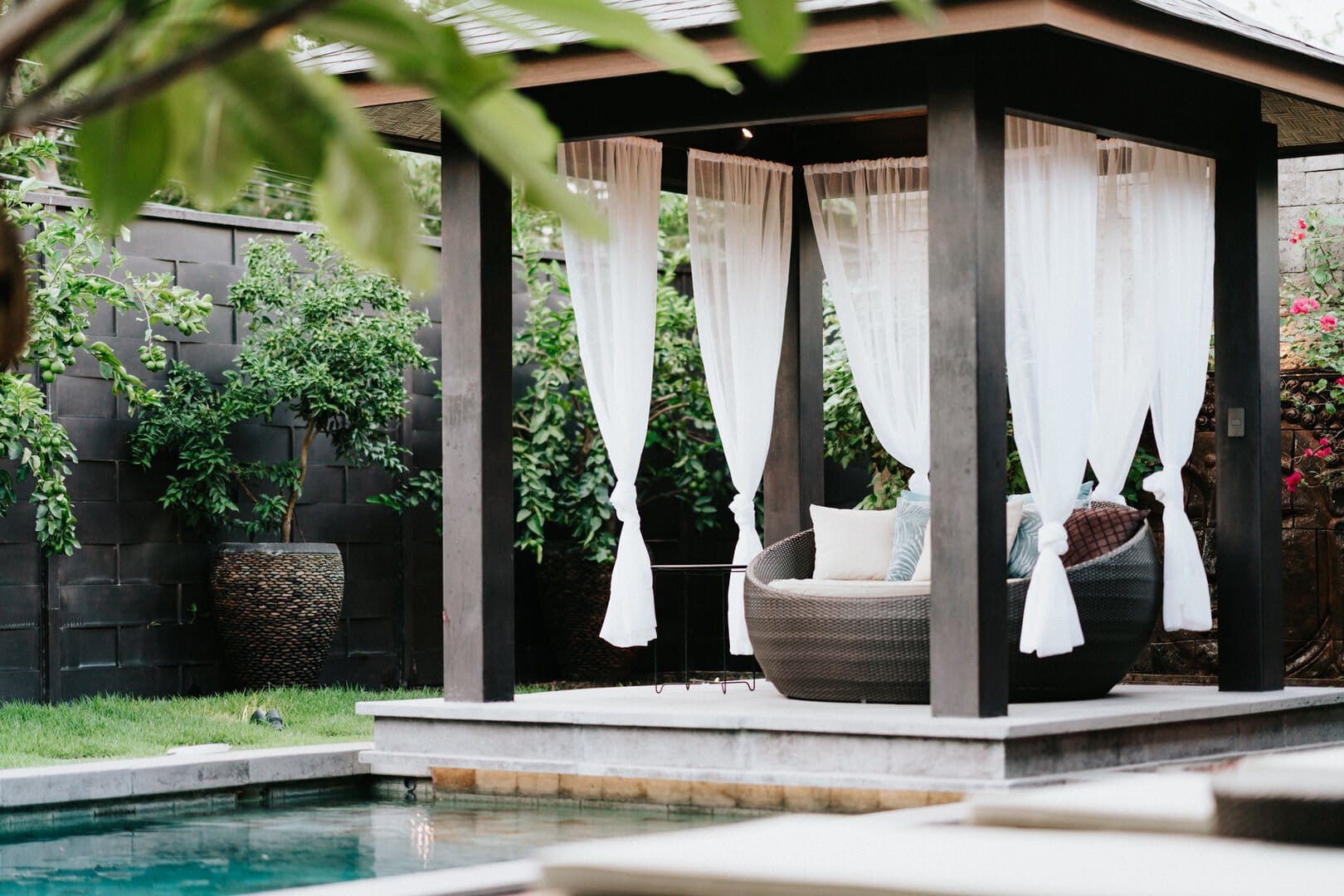 Cozy gazebo by a pool.
