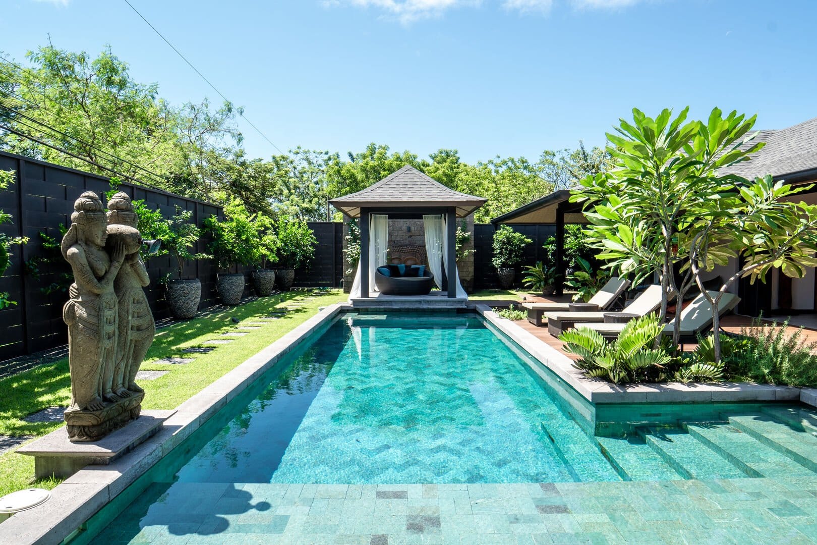 Luxurious poolside with gazebo view.