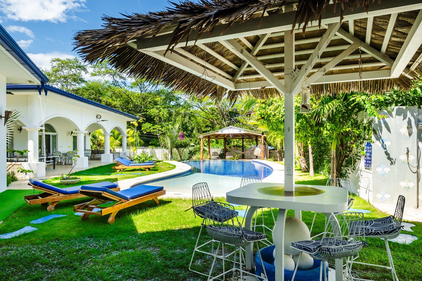 Tropical villa with poolside lounge.