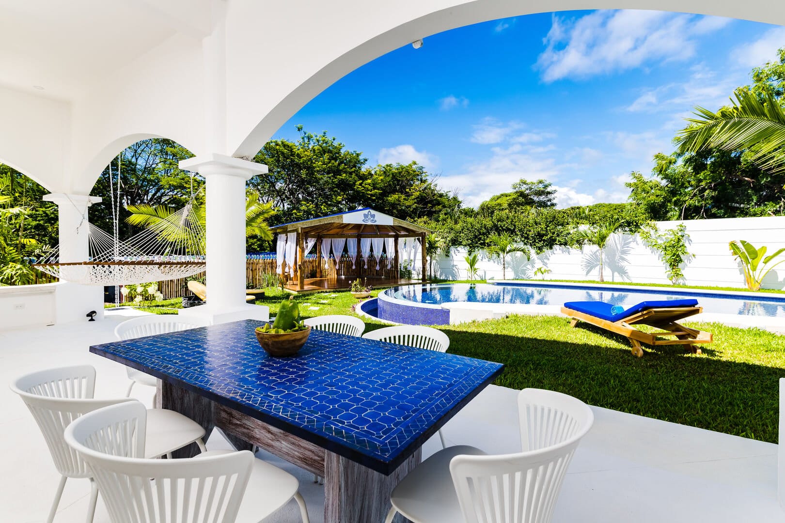 Outdoor patio, hammock, pool, gazebo.