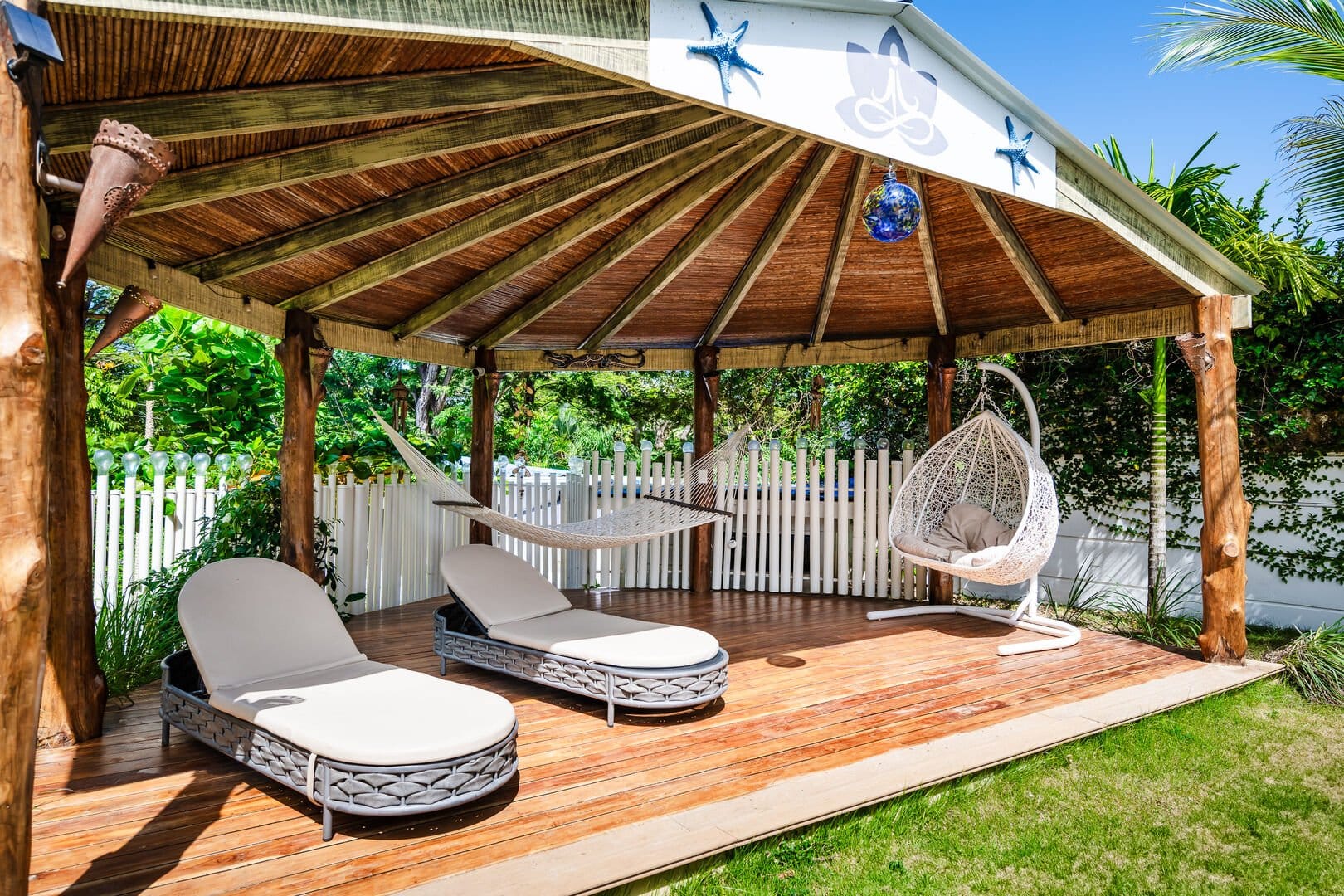 Open gazebo with lounge seating.