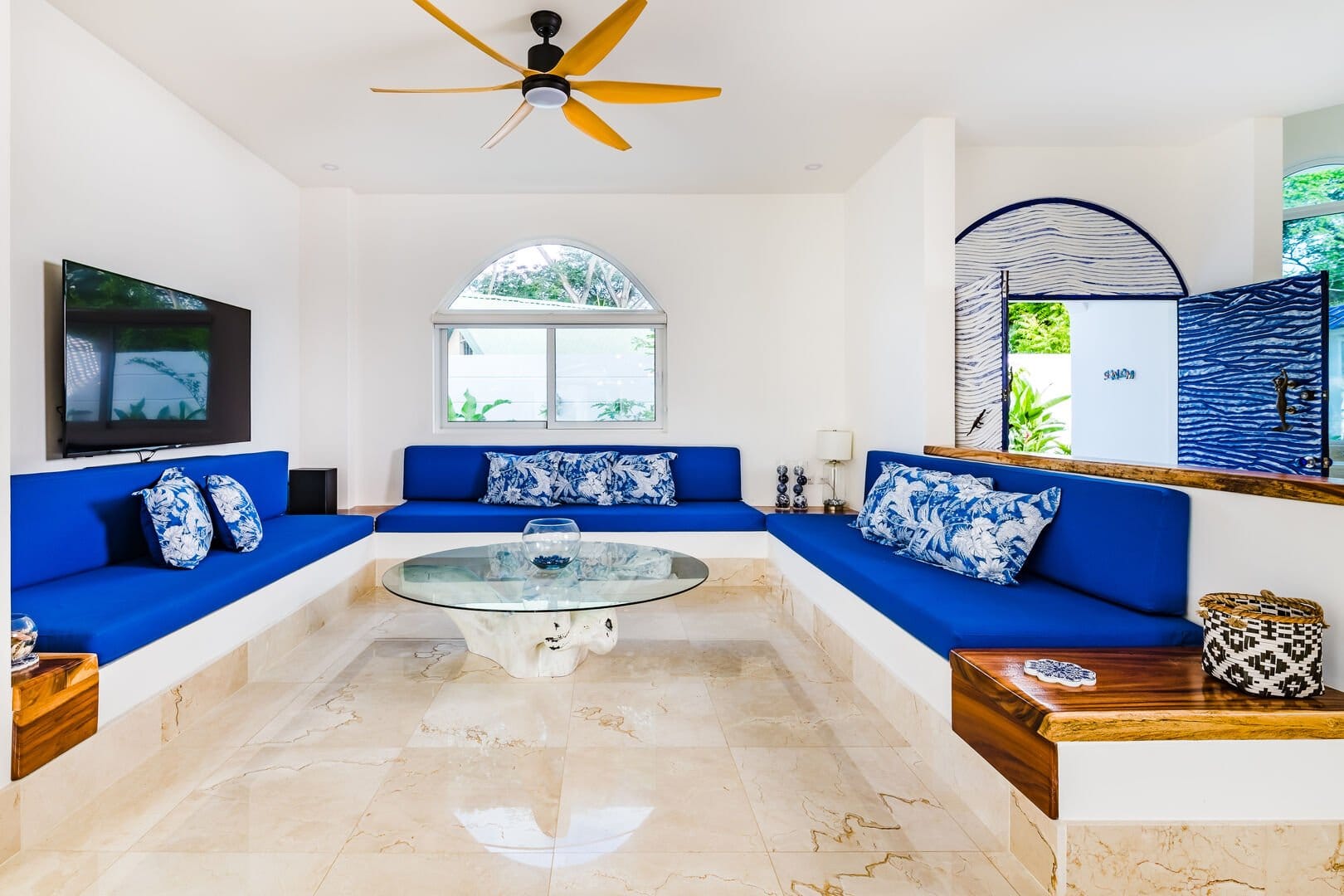Modern living room, blue seating, decor.