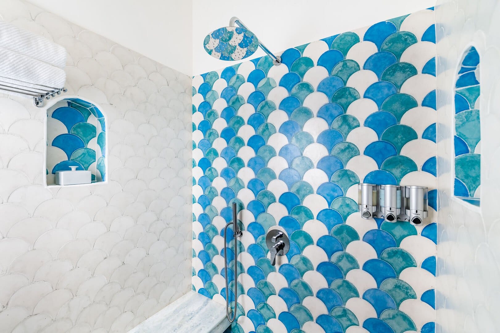 Shower with blue tiled wall.