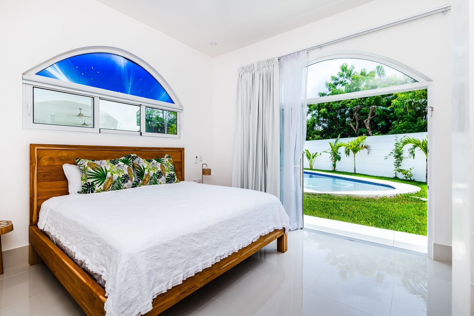Bright bedroom with pool view.