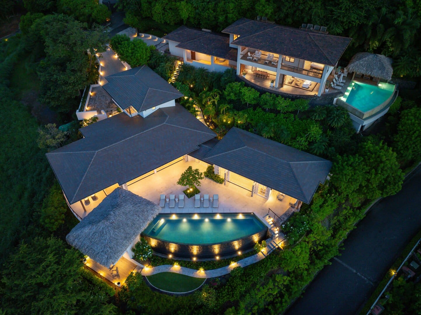 Luxurious villa with illuminated pool.
