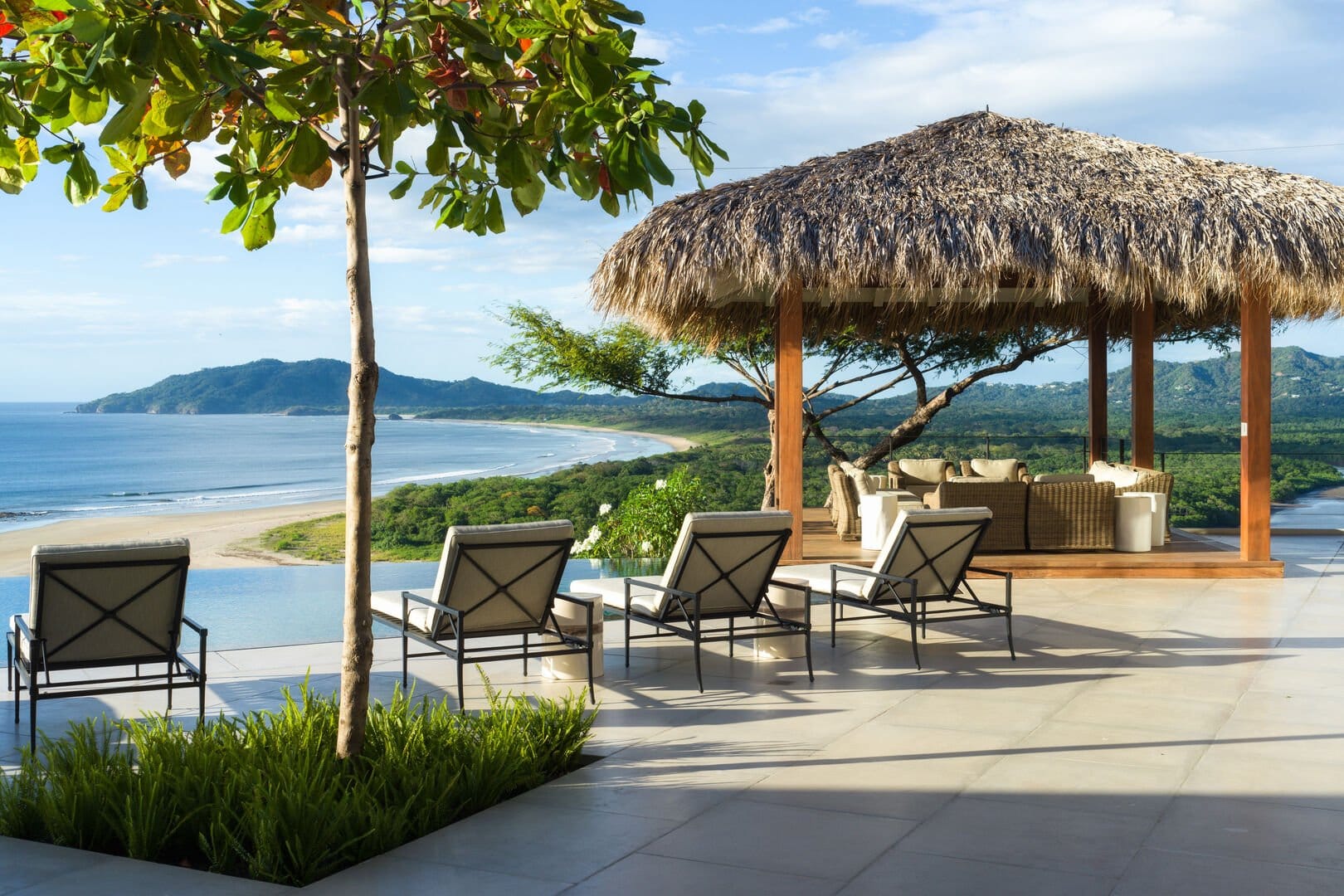 Beachside patio with lounge chairs.