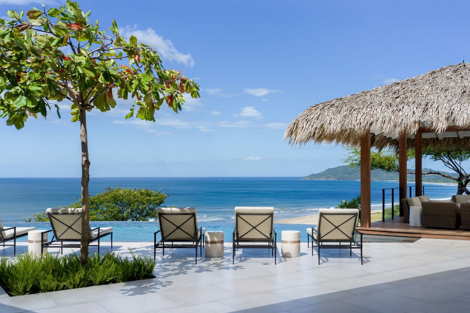 Ocean view with loungers and hut.