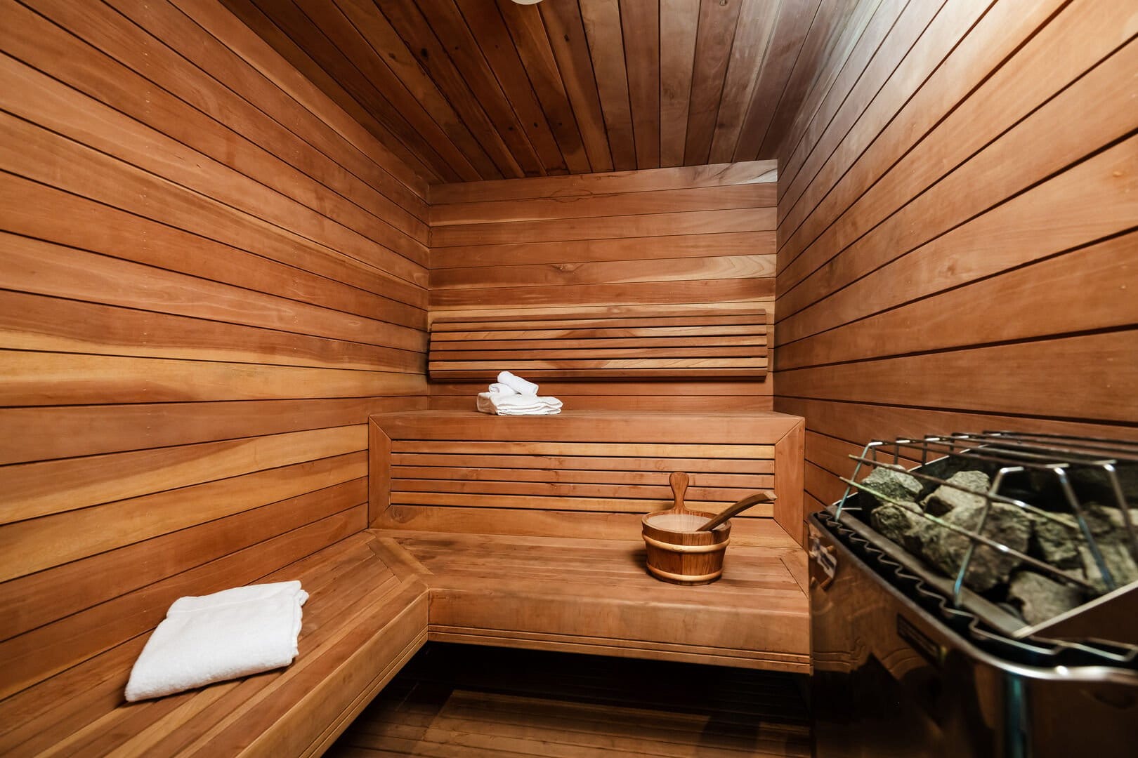 Wooden sauna interior with stones.