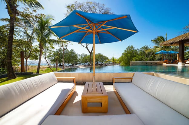 Outdoor seating with blue umbrella.